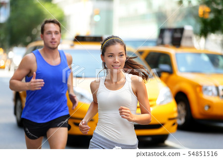 Couple running on fifth avenue, New York NYC Couple running on fifth avenue, New York NYC 54851516
