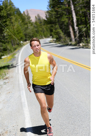 Running athlete man jogging on nature road 54851664