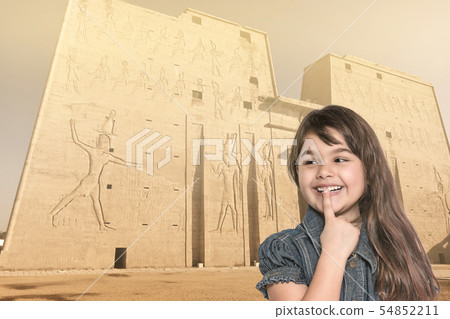 Smiling little girl is standing in front of Edfu Smiling little girl is standing in front of Edfu 54852211