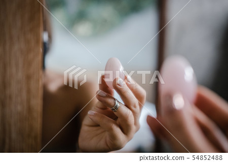 Woman holds yoni egg in hand Woman holds yoni egg in hand 54852488