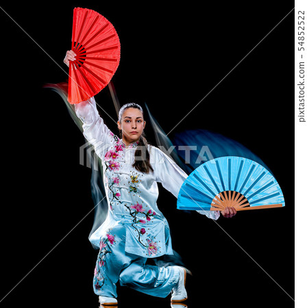 woman Tai Chi Chuan Tadjiquan posture isolated black background light painting woman Tai Chi Chuan Tadjiquan posture isolated black background light painting 54852522