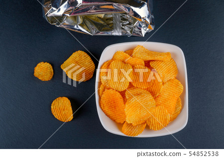 delicious golden paprika chips in a bowl  54852538