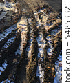 Road with frozen ground and broken ice. 54853321