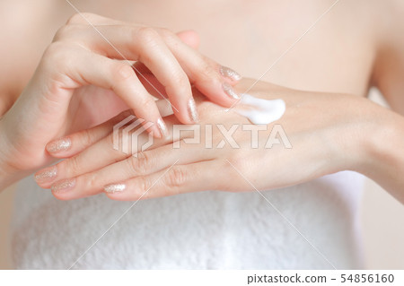 Woman applying moisturizing cream/lotion on hands. Woman applying moisturizing cream/lotion on hands. 54856160