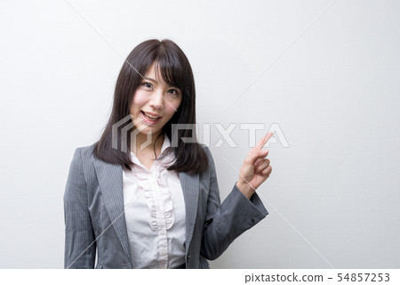 Woman pointing at open mouth and pointing 54857253