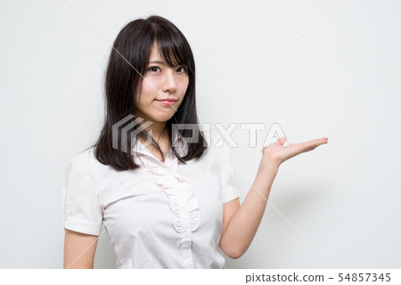 Woman who closes mouth and guides with palm Woman who closes mouth and guides with palm 54857345
