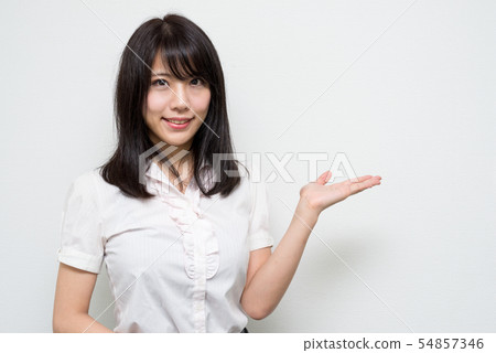 Woman showing teeth and guiding with palm Woman showing teeth and guiding with palm 54857346
