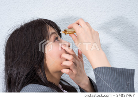 Business woman marking eye drops Business woman marking eye drops 54857467