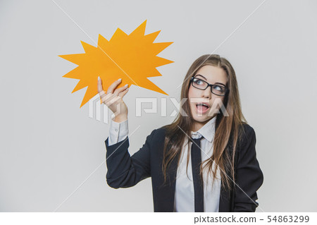 Adorable business woman is holding a orange speech bubble, which is star-shaped, isolated, on the Adorable business woman is holding a orange speech bubble, which is star-shaped, isolated, on the 54863299