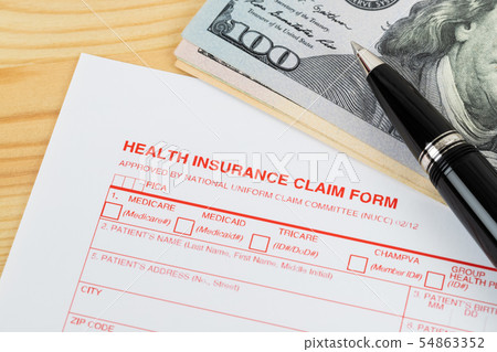 Health insurance claim form with pen on wooden Health insurance claim form with pen on wooden 54863352