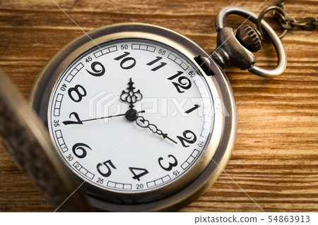 Vintage pocket watch clock on wooden background Vintage pocket watch clock on wooden background 54863913
