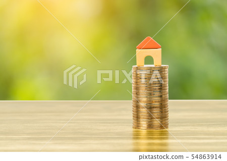 Mini model house on coins stack concept for 54863914