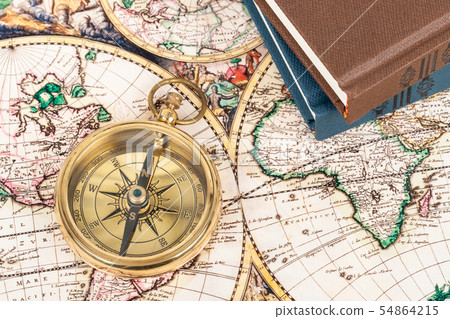 Compass on vintage ancient map with book, concept Compass on vintage ancient map with book, concept 54864215