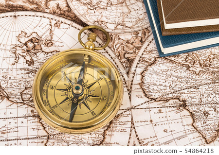 Compass on vintage ancient map with book, concept Compass on vintage ancient map with book, concept 54864218