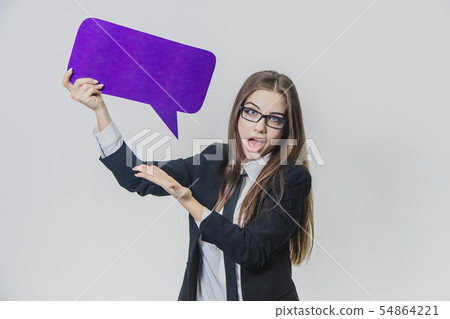Young woman is holding a violet speech bubble over herself, which is rectangular-shaped, isolated 54864221