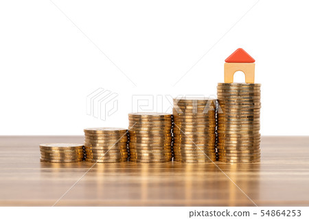 Mini model house on coins stack concept for 54864253