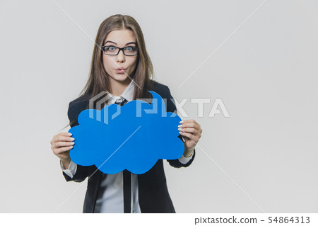 Young woman is holding a blue speech bubble in front of herself, which is cloud-shaped, isolated, on 54864313