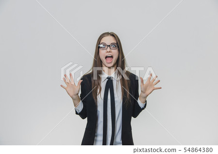 Successful woman is shouting about her triumph spreading her both hands, showing palms. Business Successful woman is shouting about her triumph spreading her both hands, showing palms. Business 54864380