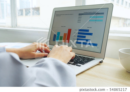 Woman is typing summary data work on notebook 's 54865217