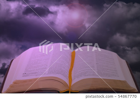 Open bible book on dramatic shiny sky 54867770