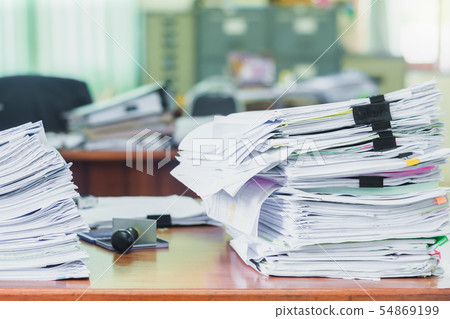Heap of papers work stack documents on office desk ,business documents billing and examination to Heap of papers work stack documents on office desk ,business documents billing and examination to 54869199