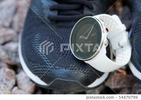 Sport watch on the running shoes.  54870799