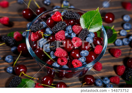 Summer, ripe berries in a transparent bowl Summer, ripe berries in a transparent bowl 54873752