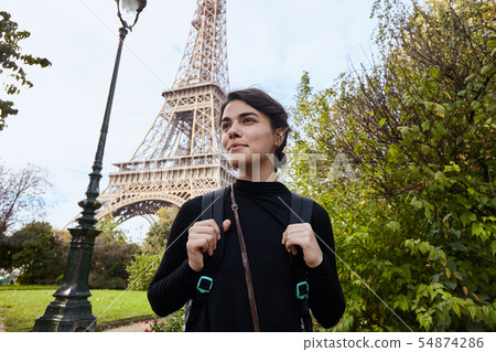 Beautiful smiling girl posing on the background of the Eiffel Tower. Paris, Champ de Mars 54874286