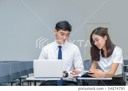 Students in uniform working and reading Students in uniform working and reading 54874795