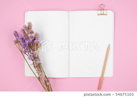 Top view of notebook and violet flower 54875103