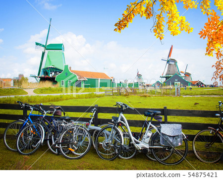 dutch windmills with bikes in Zaanse Schans dutch windmills with bikes in Zaanse Schans 54875421
