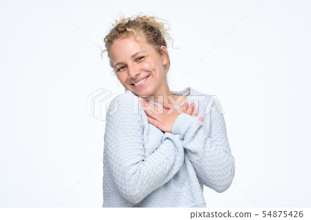 Woman smiling broadly glad to receive compliments from friends 54875426