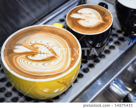 Cup of latte or cappuccino with latte art. Cup of latte or cappuccino with latte art. 54875435