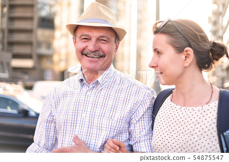 Hispanic father in summer hat and daughter walking outdoor together Hispanic father in summer hat and daughter walking outdoor together 54875547
