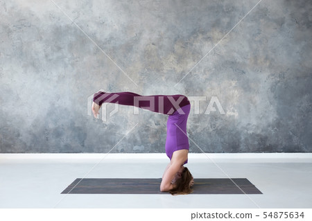 woman practicing yoga, standing in salamba sirsasana exercise, headstand pose woman practicing yoga, standing in salamba sirsasana exercise, headstand pose 54875634