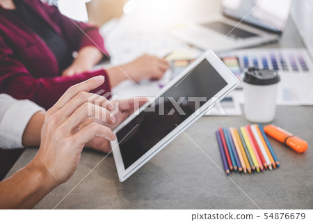 Teamwork of young creative designers working on 54876679