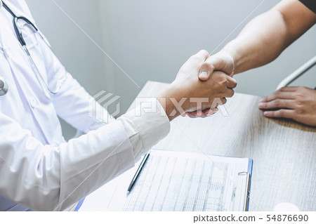 Doctor having shaking hands to congrats with 54876690