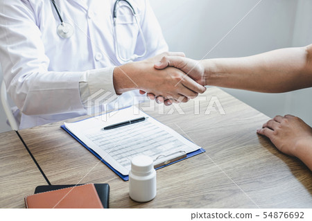 Doctor having shaking hands to congrats with 54876692