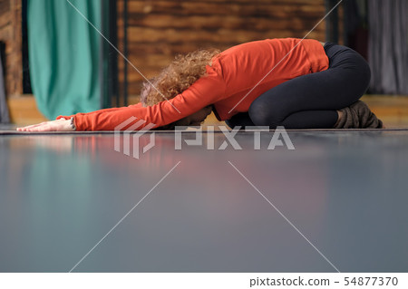Young woman practicing yoga, doing Child exercise, Balasana pose. 54877370