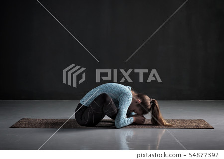 woman doing yoga or pilates butterfly exercise, sitting in baddha konasana woman doing yoga or pilates butterfly exercise, sitting in baddha konasana 54877392