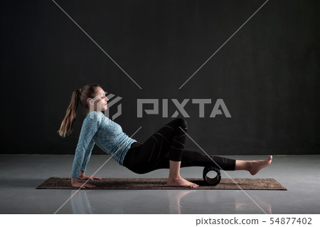 Woman uses foam roller to remove pain, stretch and massage muscles of legs. Woman uses foam roller to remove pain, stretch and massage muscles of legs. 54877402