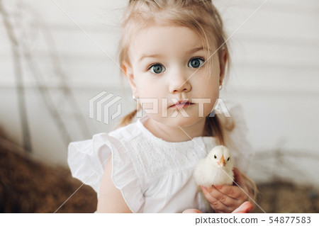 Lovely girl with big beautiful eyes keeping little Lovely girl with big beautiful eyes keeping little 54877583