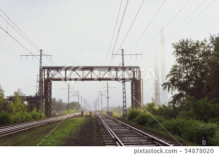 railway tracks going into the fog, pipelines and 54878020