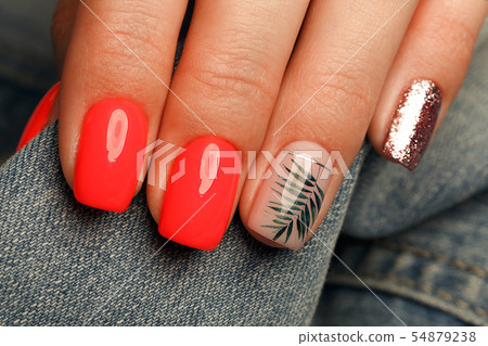 Bright neon red manicure on female hands on the background of jeans. Nail design. Beauty hands. Bright neon red manicure on female hands on the background of jeans. Nail design. Beauty hands. 54879238