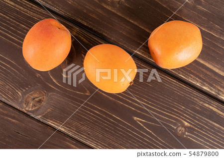Fresh orange apricot on brown wood 54879800