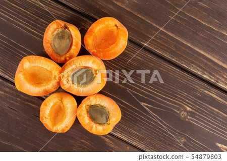 Fresh orange apricot on brown wood 54879803