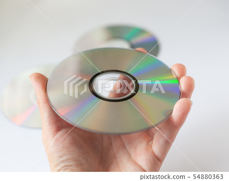 cd compact disc in the hand on white background  54880363