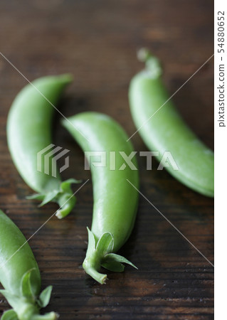 Image photograph of peas taken with natural wood grain background Image photograph of peas taken with natural wood grain background 54880652