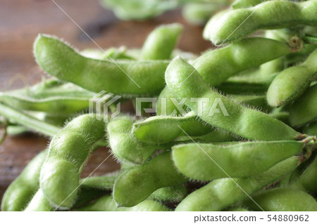 Painful edamame on wooden board background Painful edamame on wooden board background 54880962