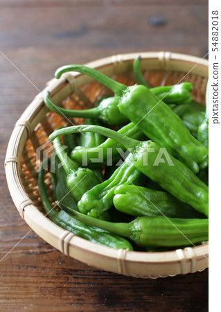 Wood plate of green summer vegetables on a wood board background Wood plate of green summer vegetables on a wood board background 54882018